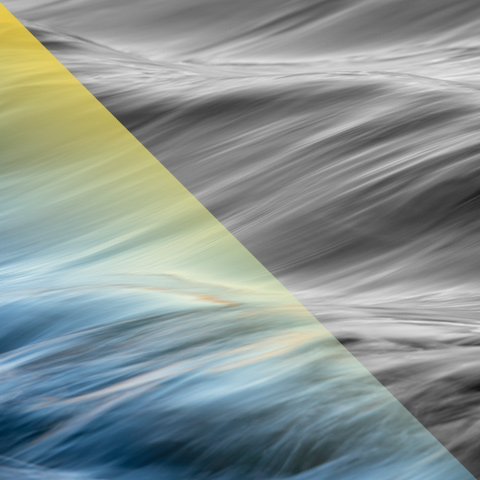 close up view of gentle waves with a warm light reflecting 