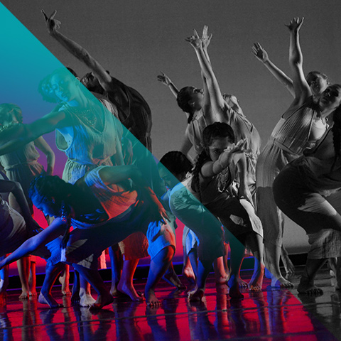 a group of dancers perform on stage in dramatic lighting