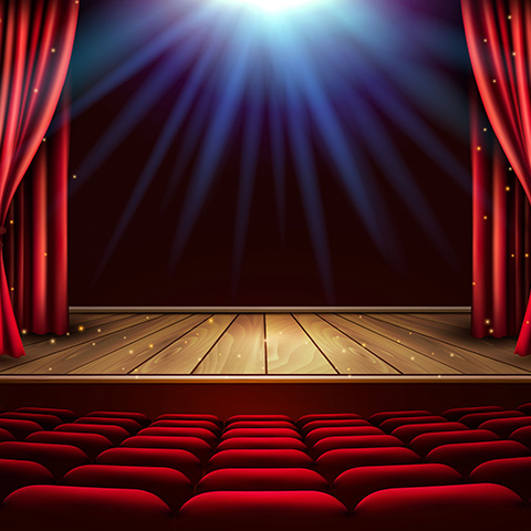 Stage with red curtains and overhead lighting