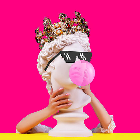 Statue bust wearing a crown, sunglasses, and chewing bubblegum