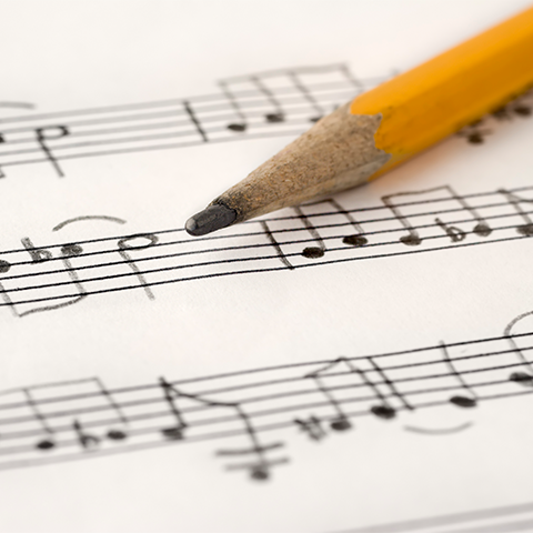 manuscript paper with pencil