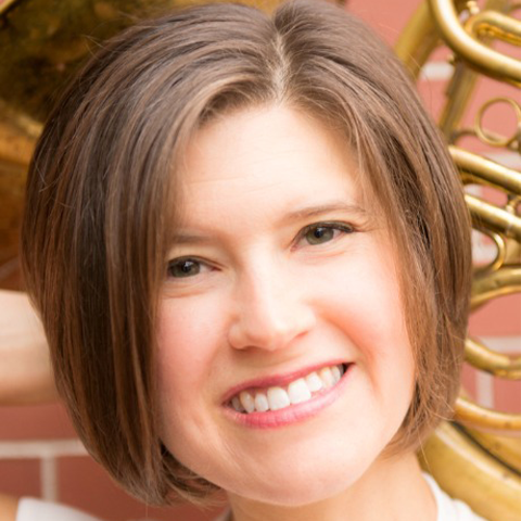 Anne Howarth smiling holding french horn