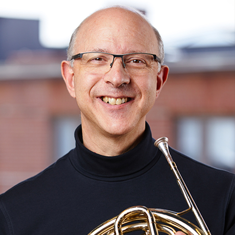 Eli Epstein smiling with french horn