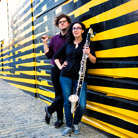 two musicians leaning on wall