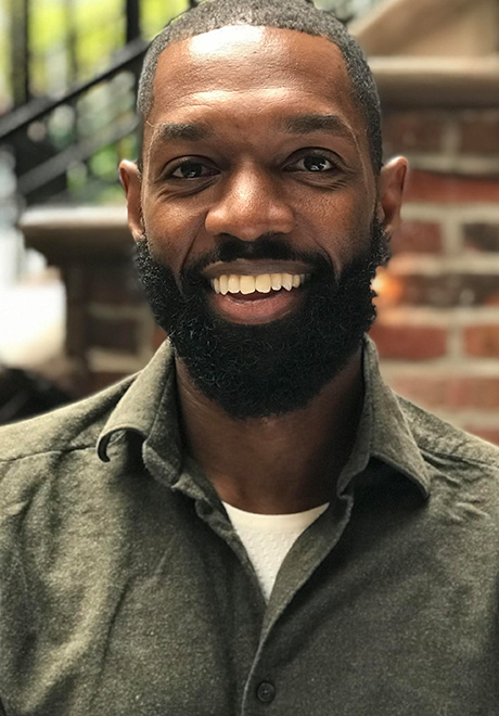 Ramone Owens smiling in green shirt