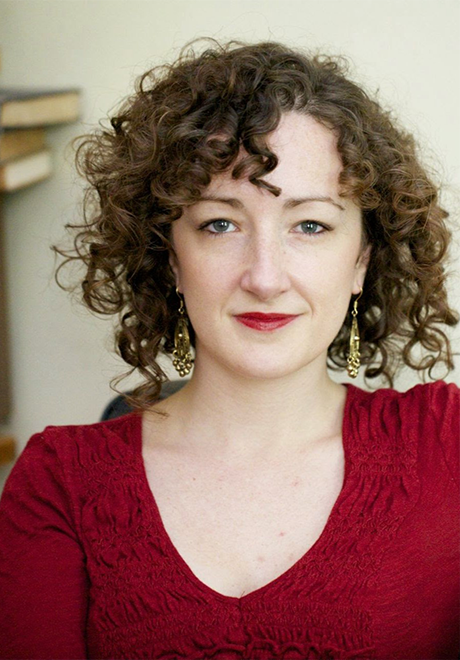 Amanda Friou headshot: smizing in red shirt