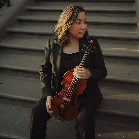 Brianna Ingber holding a violin