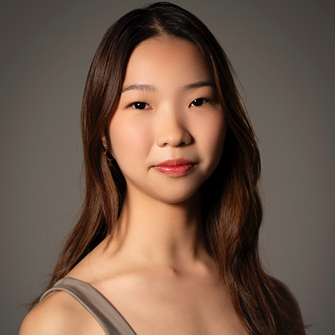 Ai Li Mok headshot; wearing gray/neutral-toned tank top