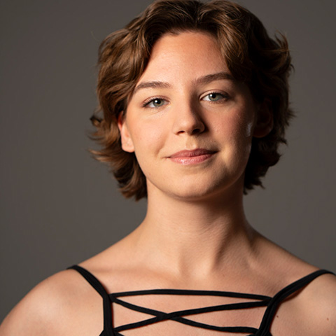 Ava Grebe headshot; wearing black-strapped tank top