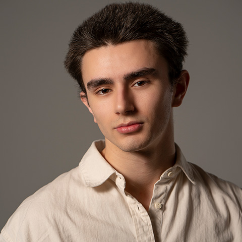 Daede Ott headshot; wearing an off-white button up shirt