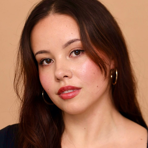 Arriana Glenn headshot: in front of peach brown background