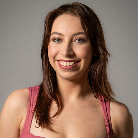 Jaqi Gendreau headshot; wearing a pink tank top and smiling