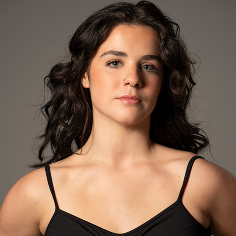 Katie Corrao headshot; wearing a black spaghetti-strapped top
