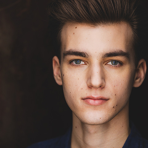 Jack Parrotta headshot: in front of a black background