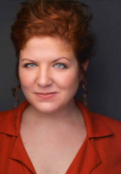 Meagan Lewis-Michelson headshot, wearing red shirt and grinning