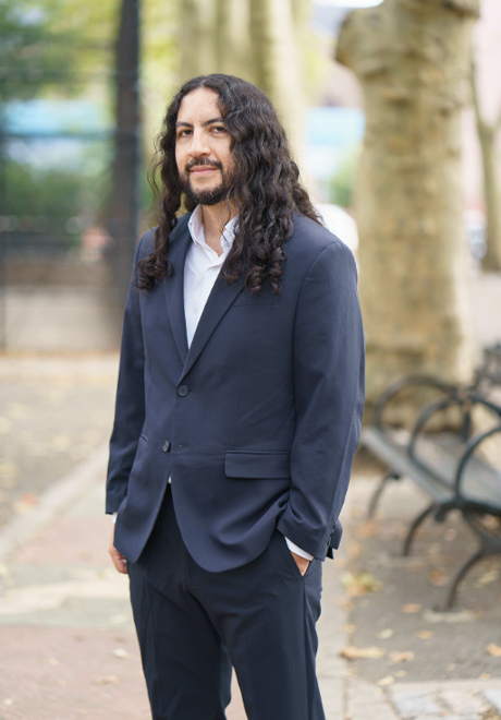 Manuel Garcia-Orozco headshot: smiling in suit
