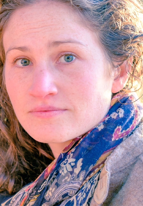 Sarah Konner headshot: wearing a blue scarf.