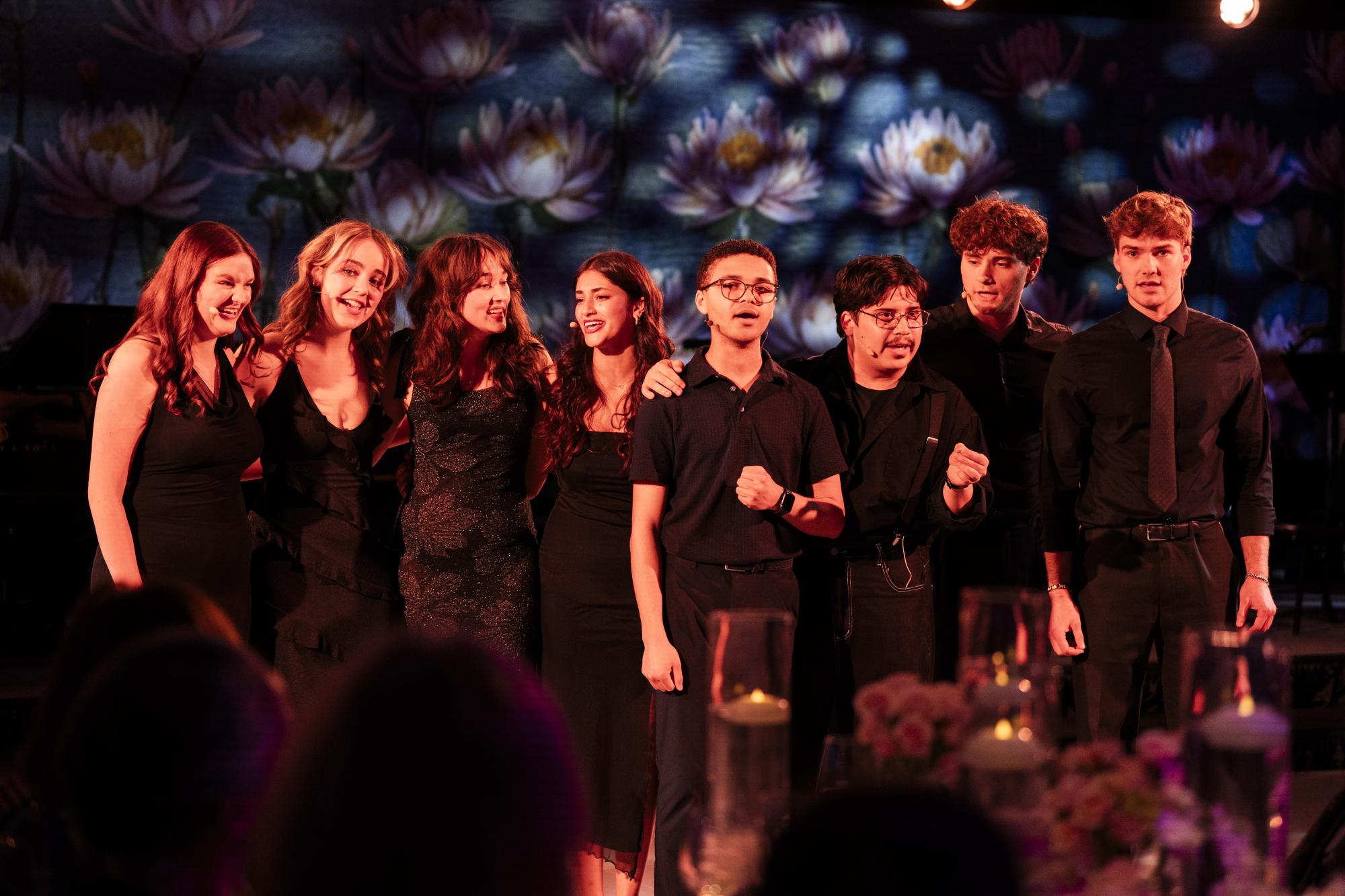 Musical Theater students on stage in all black clothing singing
