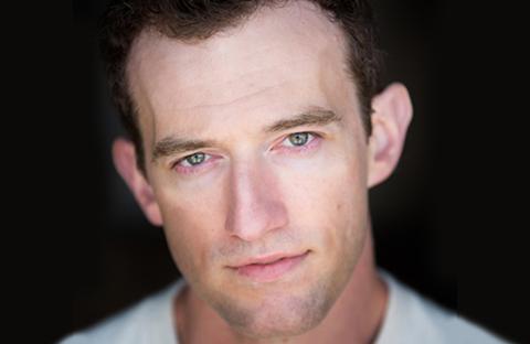 C. Robin Marcotte headshot with black background